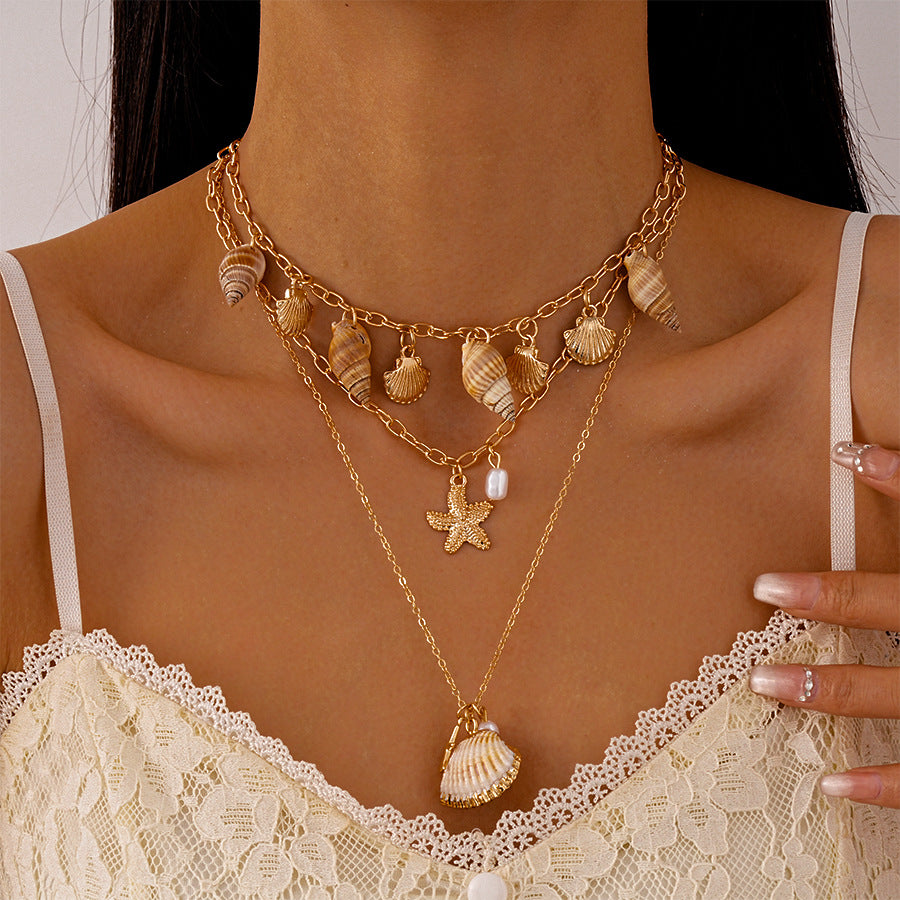 Golden seashell layered necklace set worn