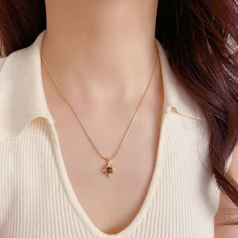 Gold tiger's eye sunburst pendant worn